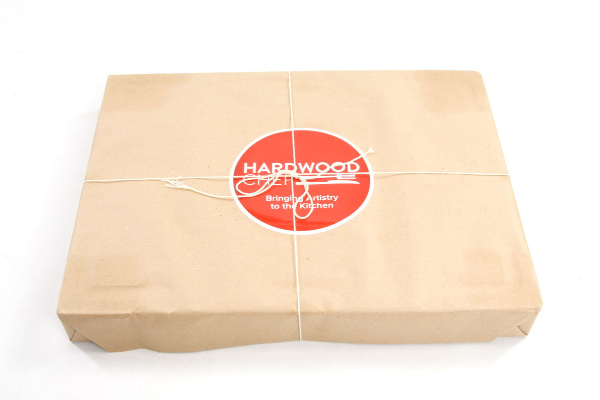 The board wrapped in butcher paper, tied with string and sealed with a Hardwood Chef sticker